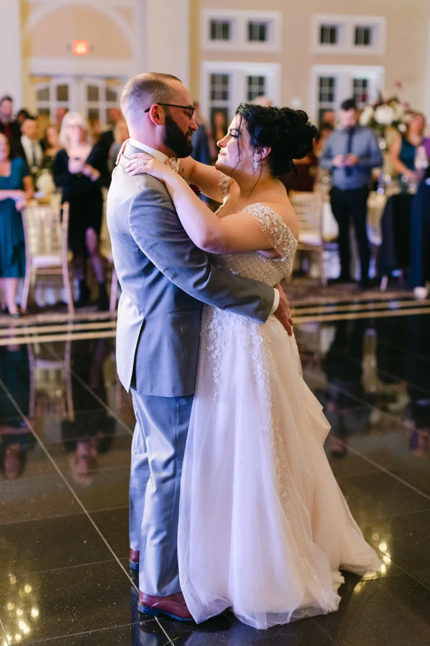 A newly married couple sharing their first dance with Live Wire performing in the background