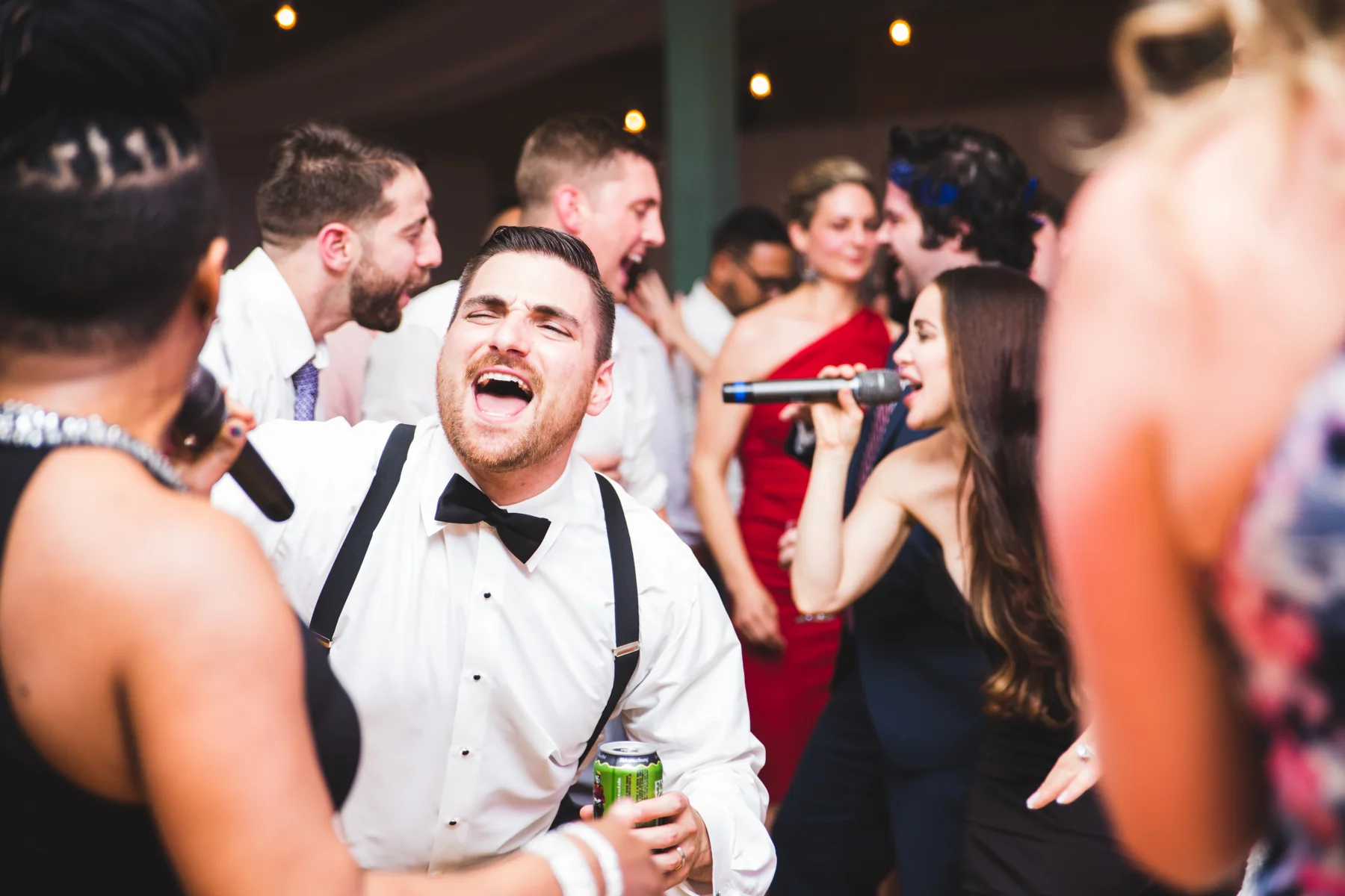 Live Wire vocalists sharing a singalong with guests in the middle of a wedding celebration